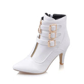 A white pointed-toe ankle boot with a front zipper, thin high heel, and three side buckles.