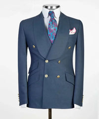 A blue double-breasted suit jacket with a shawl collar, gold buttons, and a patterned tie.