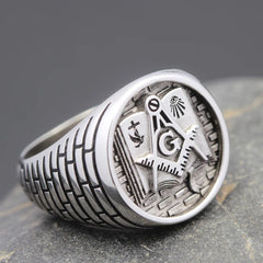 A sterling silver Masonic ring featuring a square and compass emblem over a Bible design.