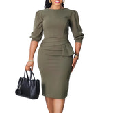 A woman wears an olive green knee-length pencil dress with a round neck and half sleeves.