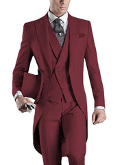 A man wears a slim-fit burgundy three-piece tuxedo with a peaked lapel and a top hat.
