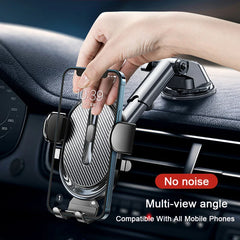 A hand places a smartphone into an adjustable car dashboard phone mount with a suction base.