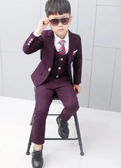A young boy wears a formal purple plaid suit consisting of a blazer, waistcoat, and trousers.
