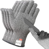 A pair of grey cut-resistant safety gloves with a knife blade resting against one palm.