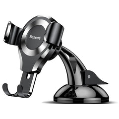 A black Baseus gravity car phone holder with a suction cup base for dashboard mounting.
