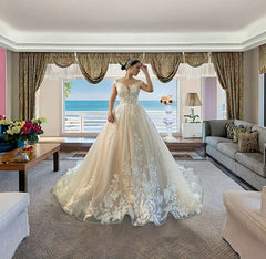 A floor-length A-line wedding dress with a scoop neckline and intricate lace floral appliques.