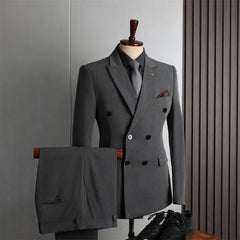 A grey double-breasted suit with a black shirt and tie displayed on a mannequin.