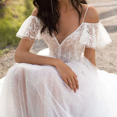 A white floor-length wedding dress featuring a lace bodice, V-neckline, and ruffled off-shoulder sleeves.