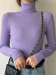 A woman wears a slim-fit, long-sleeved lavender turtleneck sweater with a ribbed knit texture.