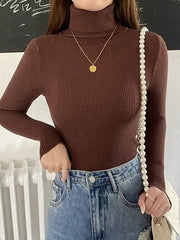 A woman wears a slim-fit brown ribbed turtleneck sweater with long sleeves.