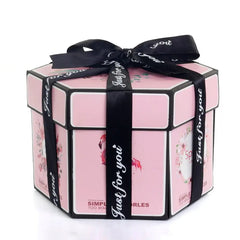 The Hexagon Explosion Box Scrapbook Album is a pink hexagonal box with black edges, floral designs, and a "Just for you" ribbon bow—perfect as a unique photo album gift.