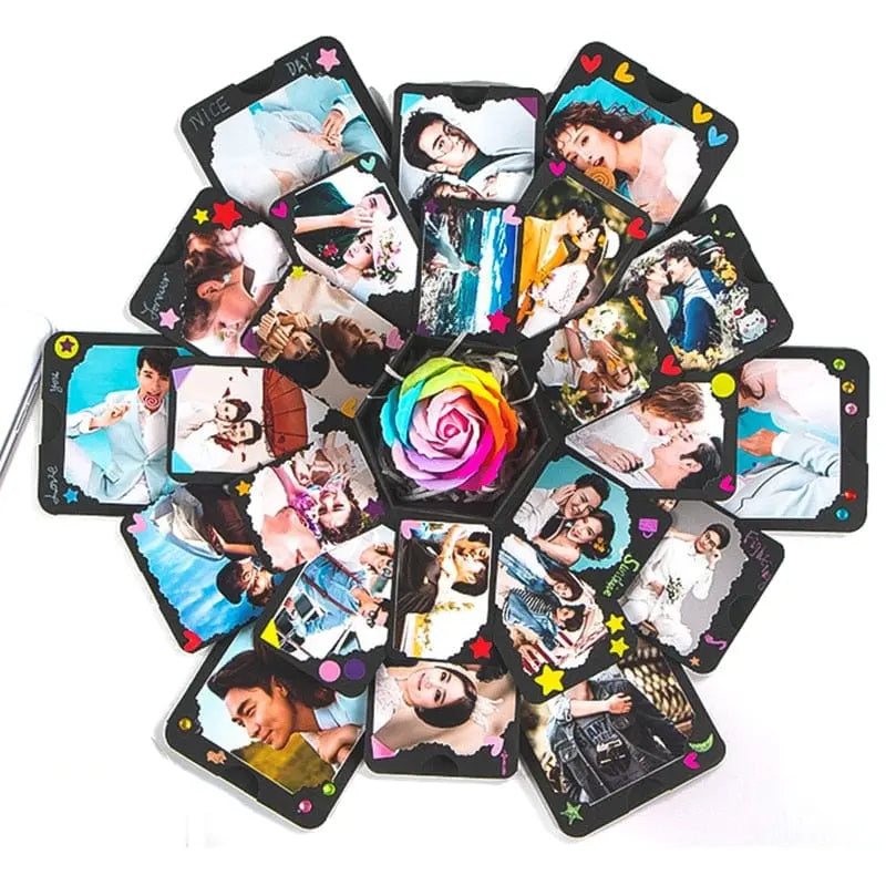 The Hexagon Explosion Box Scrapbook Album features photo cards arranged in a hexagonal display with colorful hearts, stars, and a multicolored artificial rose centerpiece—ideal for a unique DIY photo album or scrapbook gift.