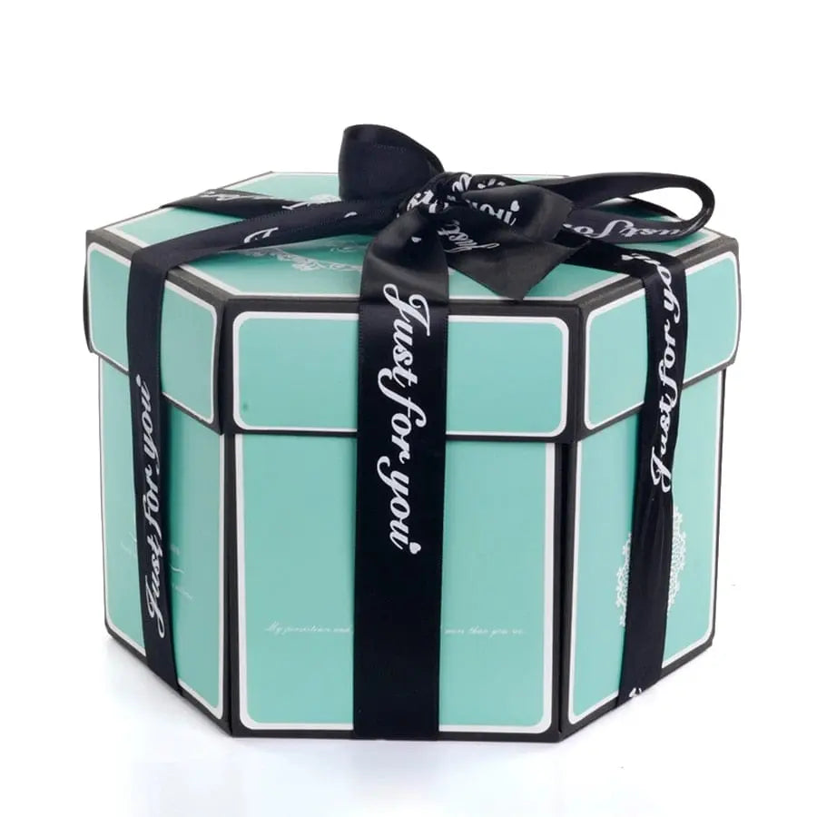 The Hexagon Explosion Box Scrapbook Album is a turquoise, hexagonal gift box with white edges, wrapped in a black "Just for you" ribbon. Ideal for DIY scrapbooking or as a photo album gift, it’s displayed closed on a white background.