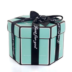 The Hexagon Explosion Box Scrapbook Album is a turquoise, hexagonal gift box with white edges, wrapped in a black "Just for you" ribbon. Ideal for DIY scrapbooking or as a photo album gift, it’s displayed closed on a white background.