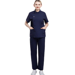 A woman wears a navy blue medical scrub set featuring a short-sleeved top with side-button detail.