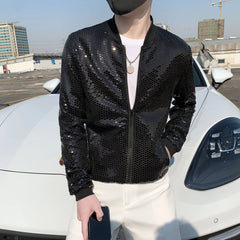 A man wears a black, thin, diamond-patterned bomber jacket with a stand collar and zipper closure.