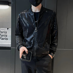 A man wears a black, thin bomber jacket featuring a shiny, diamond-patterned texture.