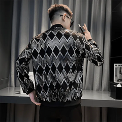 A man wears a black bomber jacket featuring a silver diamond pattern and a stand collar.
