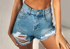 High-waisted light wash denim shorts with distressed detailing and a frayed hem.