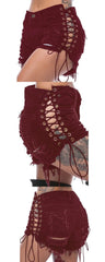 Burgundy high-waisted denim shorts featuring side lace-up detailing and distressed holes.