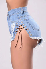 High-waisted light wash denim shorts featuring side lace-up detailing and distressed edges.