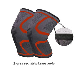 A pair of gray knee pads with red accent stripes and a built-in anti-skid strip.