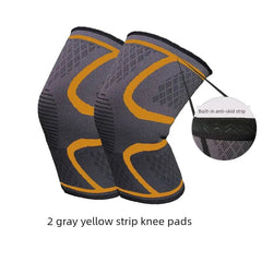 A pair of gray and yellow compression knee pads with a built-in anti-skid strip.