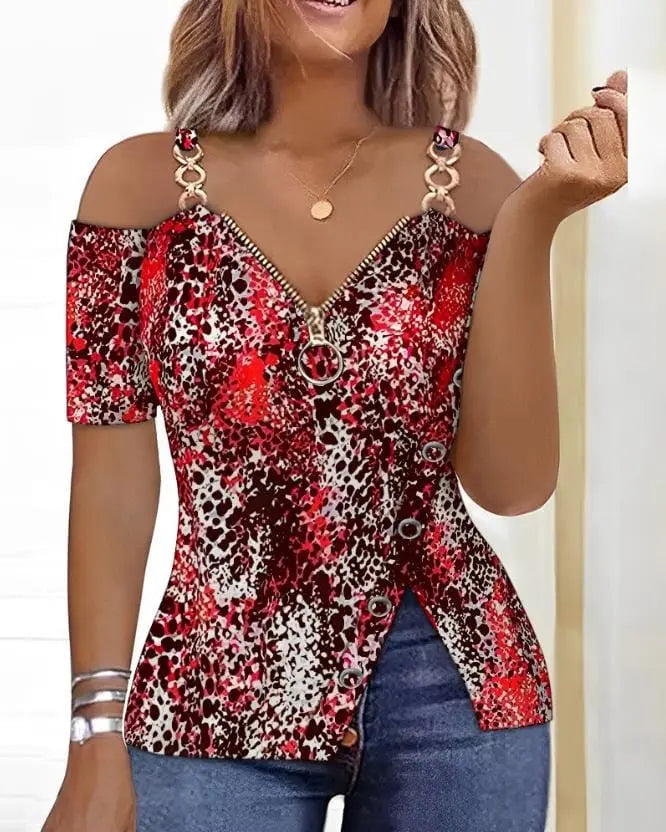 A red and black leopard print cold shoulder top with a front zipper and side button detail.