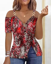 A red and black leopard print cold shoulder top with a front zipper and side button detail.
