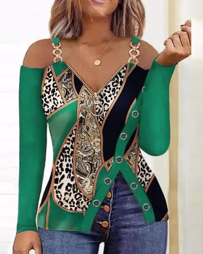 A long-sleeve cold-shoulder top featuring a green, black, and leopard print with a front zipper.
