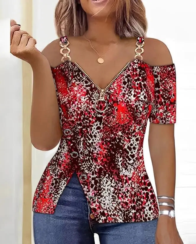 A woman wears a red and black leopard print cold-shoulder top with a front zipper and side buttons.