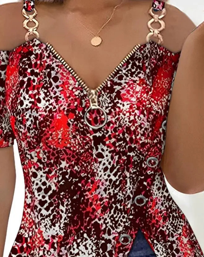A red and white leopard print cold shoulder top with a front zipper and side button detail.