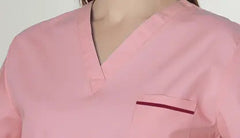 A light pink V-neck scrub top with a chest pocket featuring a dark red trim.