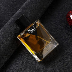 A rectangular glass bottle of men's cologne with a black cap and a No.1 label on a dark background.