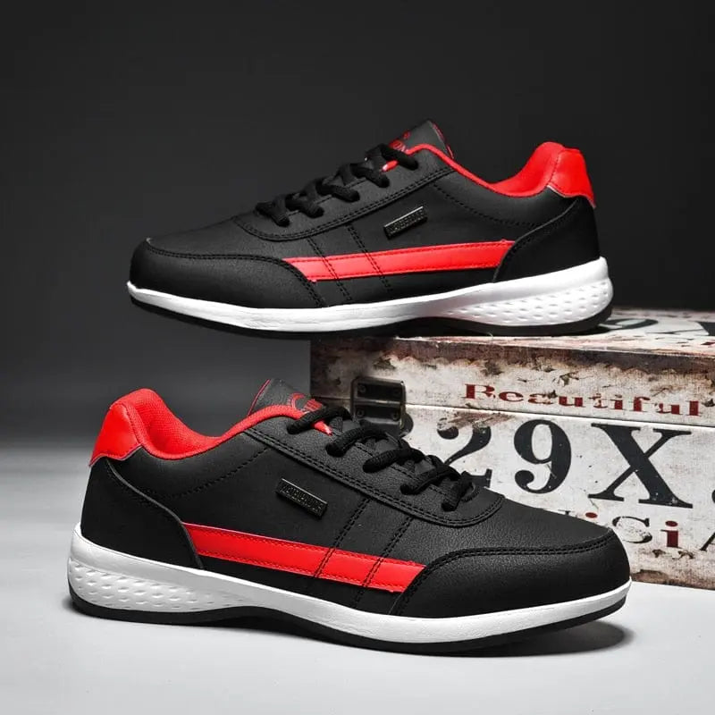 A pair of Men's Sneakers 2022 New Lightweight Vulcanized Shoes with black mesh, red accents, and a white sole is displayed side by side on a gray surface, one lace-up elevated on a rustic box marked "29X.