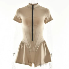 A beige short-sleeved playsuit with a front zipper and a flared skirt overlay.