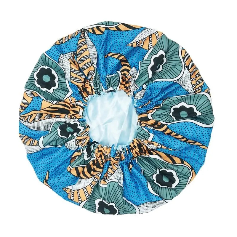 The New African Ankara Pattern Satin Lined Bonnet is a colorful, round fabric hair cover with an elastic band, featuring a blue, green, black, and yellow design—ideal as a women’s beanie or multifunctional skull cap.