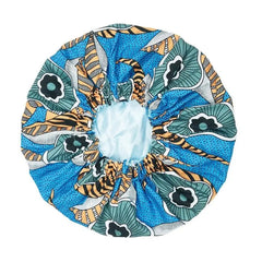 The New African Ankara Pattern Satin Lined Bonnet is a colorful, round fabric hair cover with an elastic band, featuring a blue, green, black, and yellow design—ideal as a women’s beanie or multifunctional skull cap.