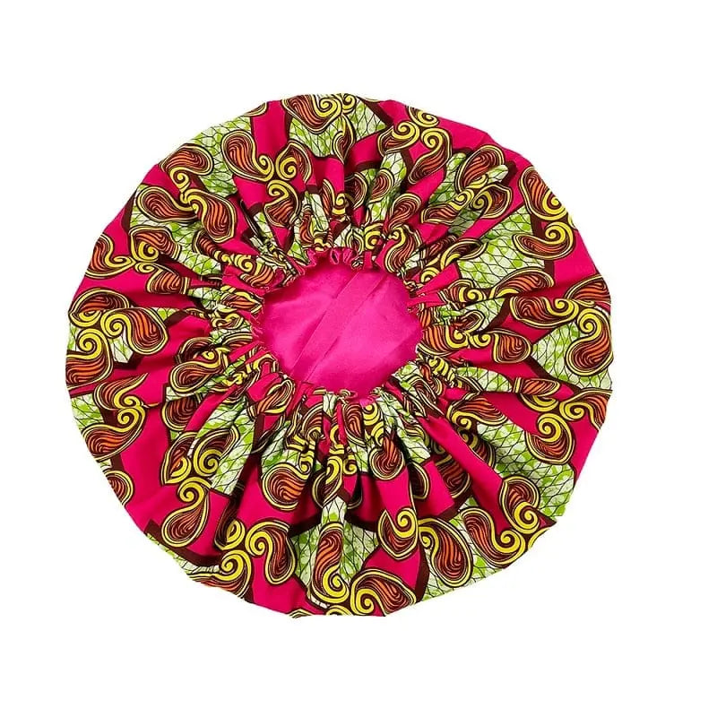 The New African Ankara Pattern Satin Lined Bonnet features a vibrant multicolor swirl design, pink inner lining, elastic band, and long ribbon. This double-layer headscarf is big size for adults and is displayed on a white background.