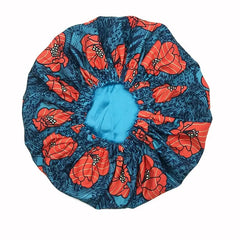 The New African Ankara Pattern Satin Lined Bonnet features vibrant red and orange floral prints on dark blue, with a gathered edge and long ribbon. This double-layer headscarf is perfect as a stylish floral headscarf or multifunctional hair cover.