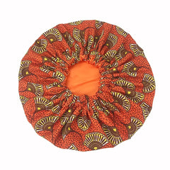 The New African Ankara Pattern Satin Lined Bonnet features a vibrant brown and yellow fan design, elastic edge, and multifunction use as a skull cap or beanie. This double layer headscarf comes in big size with a long ribbon for women.