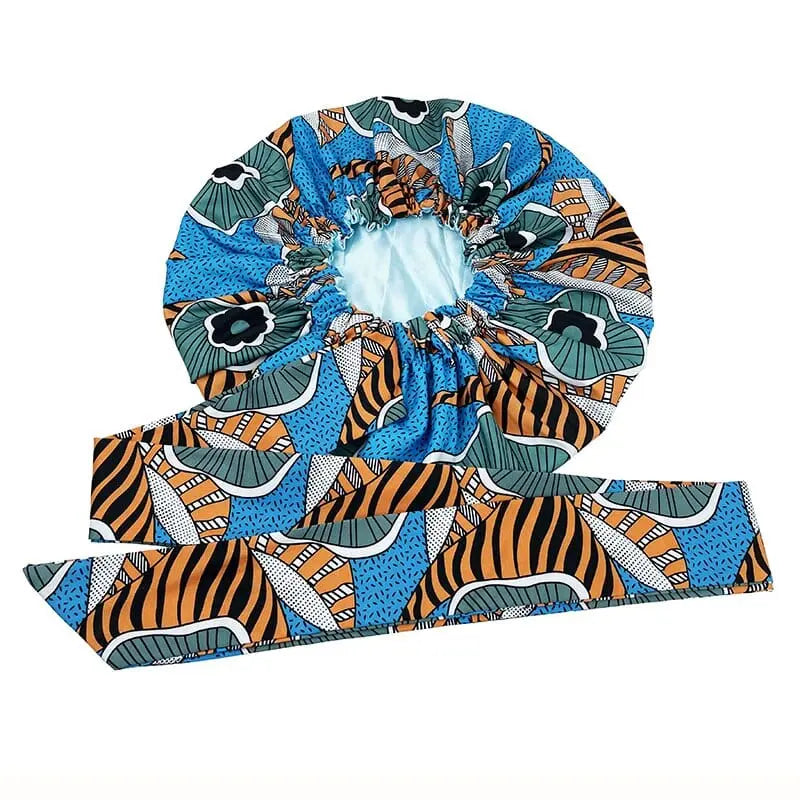 The New African Ankara Pattern Satin Lined Bonnet features abstract and floral prints in blue, orange, and green with a matching long ribbon tie. This double-layer headscarf serves as a big size multifunctional hair cover for women.