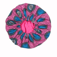 The New African Ankara Pattern Satin Lined Bonnet is a big-size, double-layered floral headscarf with elastic edges and long ribbon, designed to protect adult hair while sleeping in style.