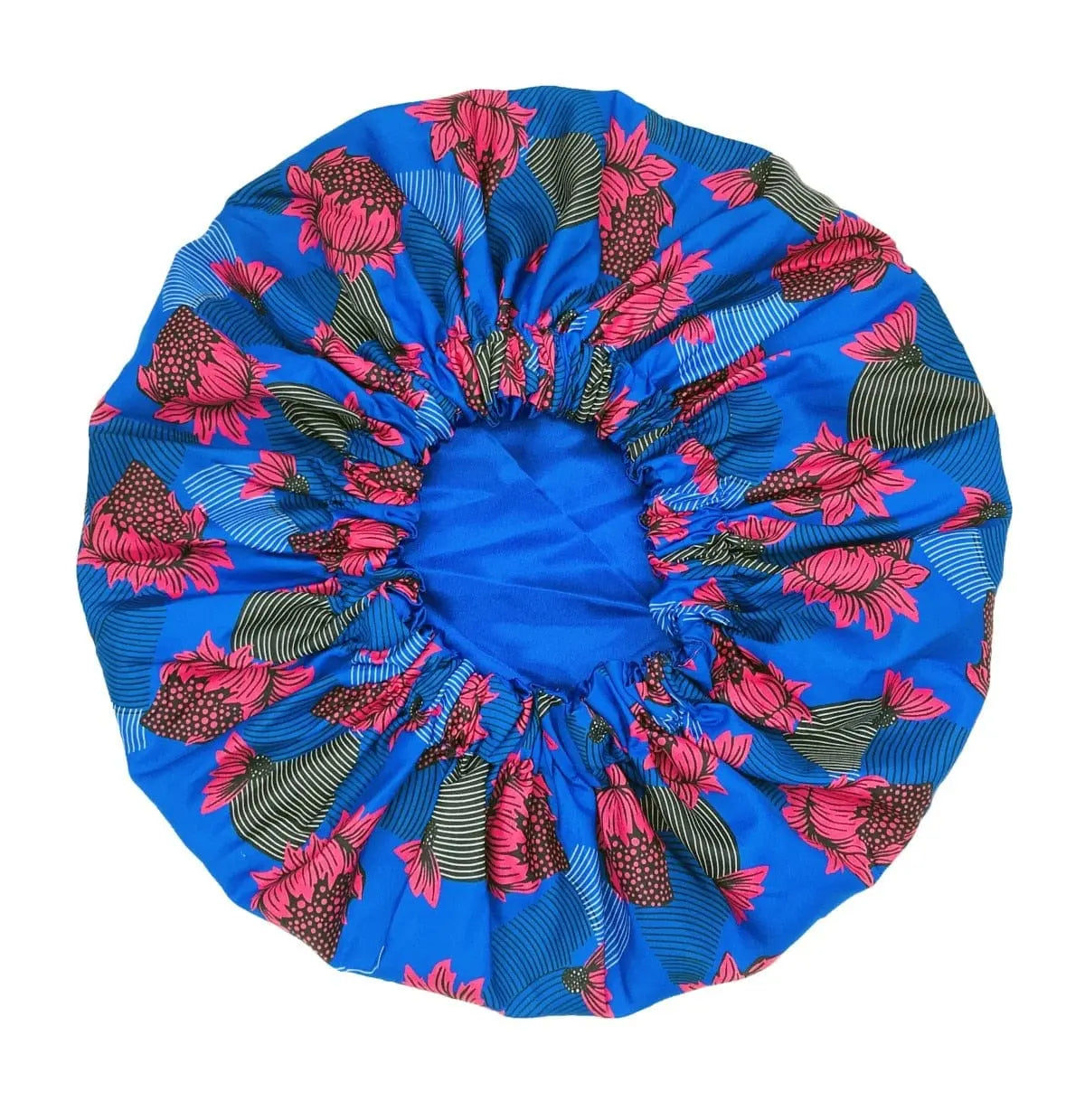 The New African Ankara Pattern Satin Lined Bonnet is a big size women’s headwrap with double layers, long ribbons, and vibrant pink and green floral patterns on blue fabric, gathered at the center with elastic for a secure fit.