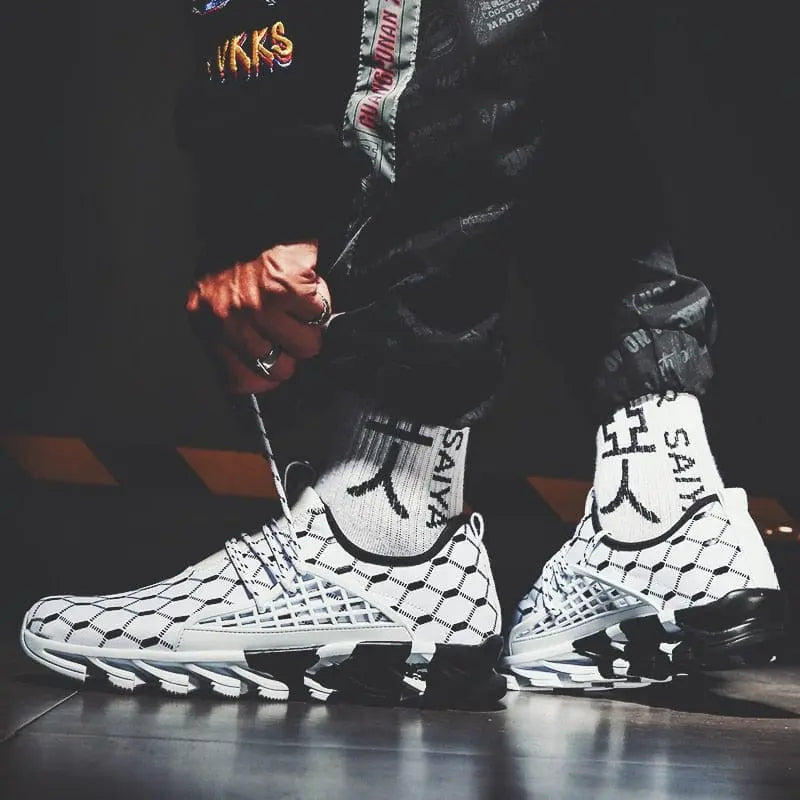 A person wears New Fashion Men Running Shoes Sports Shoes Casual Trainers Mesh Tennis Sneakers Vulcanize Shoes Zapatos De Hombre with white socks, standing on a reflective surface and adjusting their pants for a sporty, modern look.