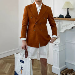 A slim-fit, double-breasted rust-colored linen suit jacket with a notched lapel.