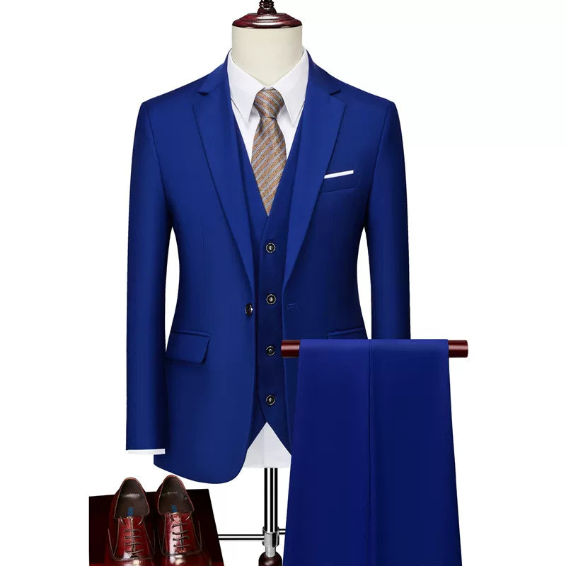 A slim-fit royal blue three-piece suit with a white shirt, patterned tie, and brown dress shoes.