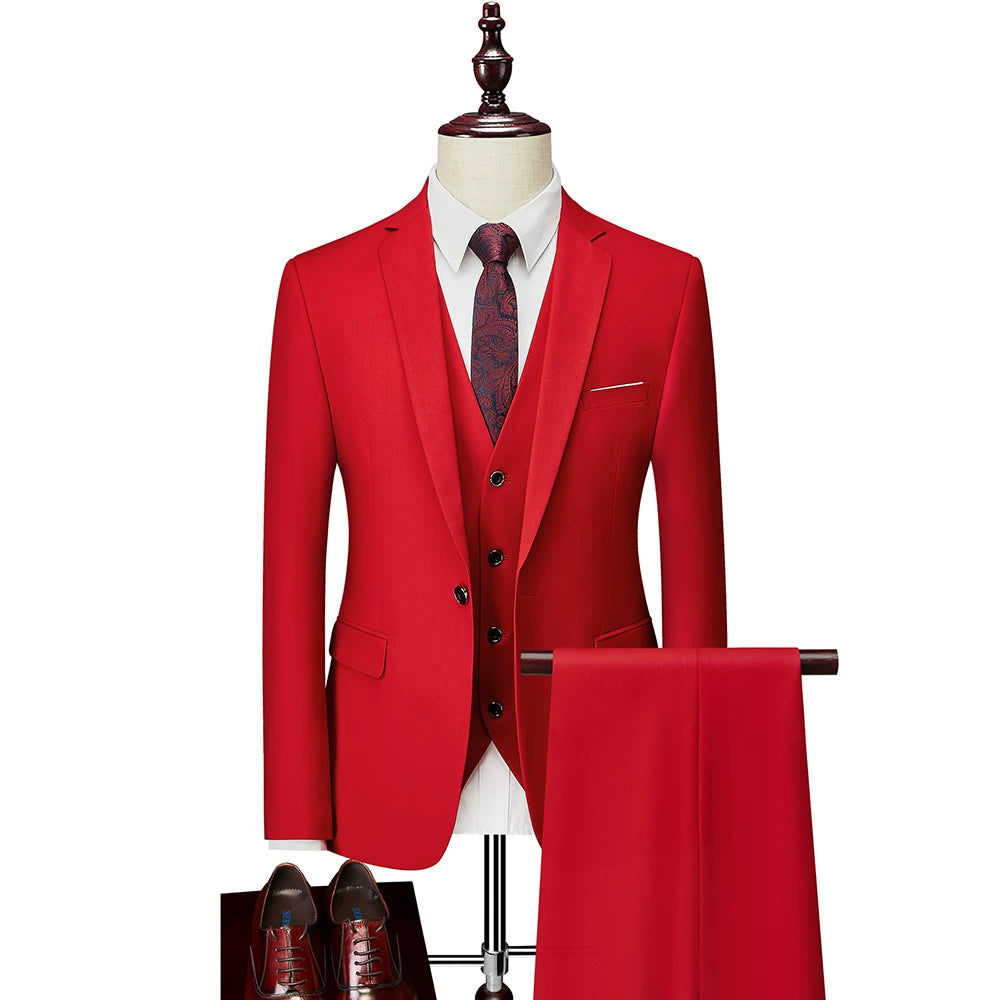 A slim-fit red three-piece suit with a patterned tie and matching trousers on a display stand.