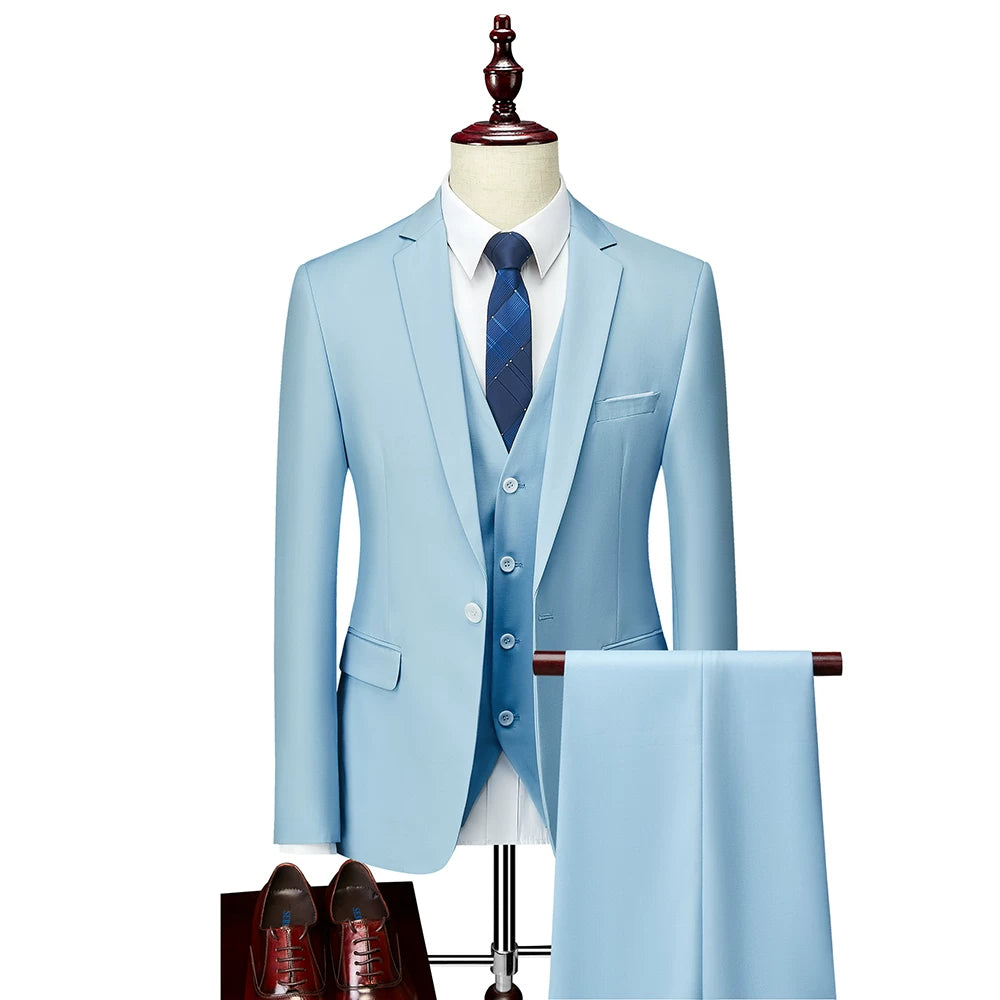 A light blue slim-fit three-piece suit with a vest, white shirt, and dark blue patterned tie.