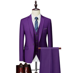 A slim-fit purple three-piece suit with a white shirt and blue tie displayed on a mannequin.